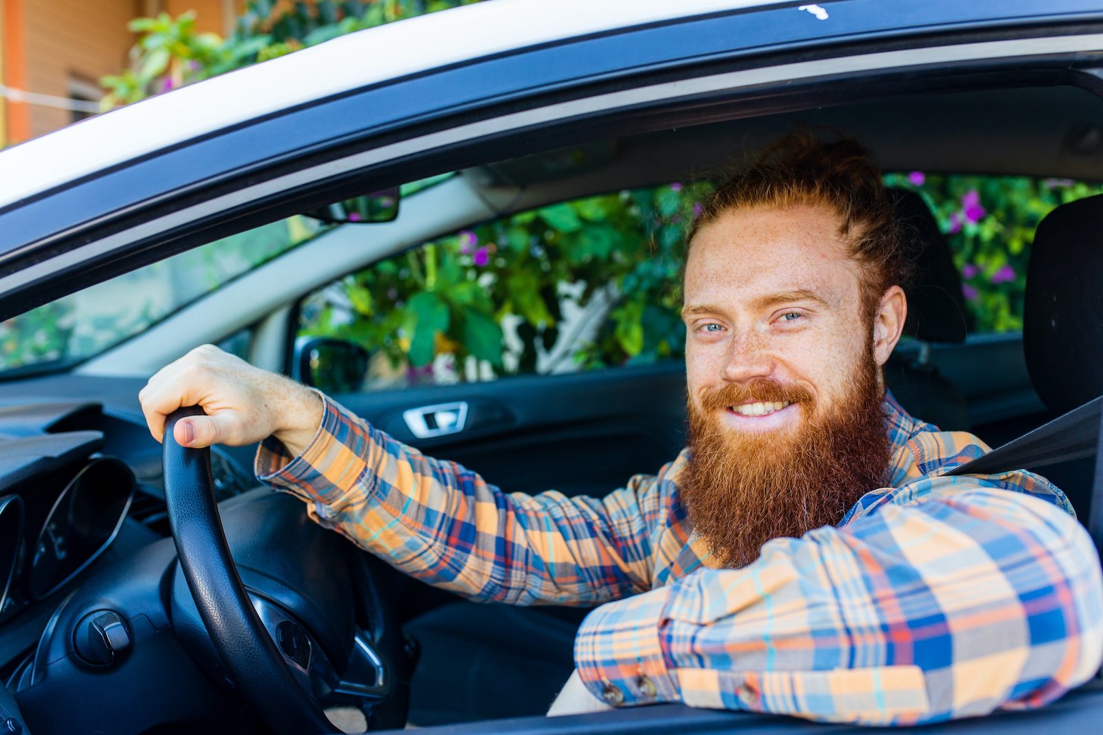 handsome-redhaired-ginger-man-with-long-beard-going-on-trip-during-summer-vacation-on-new-car.jpg